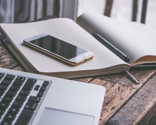 A notebook and pen on a modern office desk