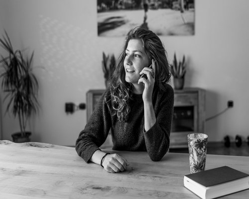 A person stretching their arms while sitting at a home desk